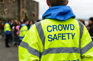 Crowd safety officer in high visibility jacket