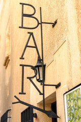 Wrought iron sign at the entrance to a bar