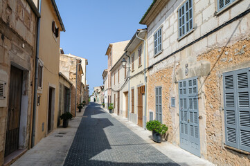 Fototapeta na wymiar Closed window shutters in an empty street, Sant Llorenc, Mallorca/Majorca