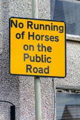 AA Street sign prohibiting the running of horses on the public road