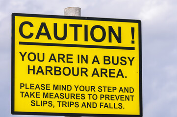 Sign at a harbour warning visitors that there will be hazards