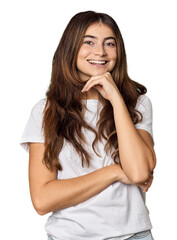 Fototapeta premium Young Caucasian woman in studio setting smiling happy and confident, touching chin with hand.