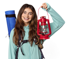 Caucasian woman with mountain gear holding lantern