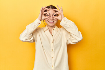 showing okay sign over eyes