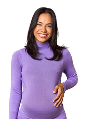 Young Filipina woman expecting a baby in studio happy, smiling and cheerful.
