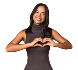 Young Filipina with long black hair in studio smiling and showing a heart shape with hands.