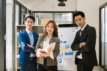 The boss stands near the board with graphs, demonstrates statistics, various personnel attending the training, introduces the new products of the company, in office..