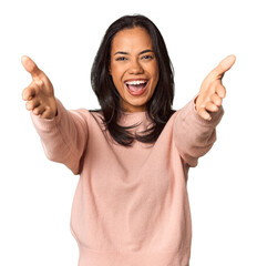 Young Filipina with long black hair in studio feels confident giving a hug to the camera.