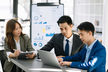 Group of Asian business meeting in planning design in creative business discussing work in the office