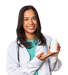 Young Filipina doctor holding medication in studio