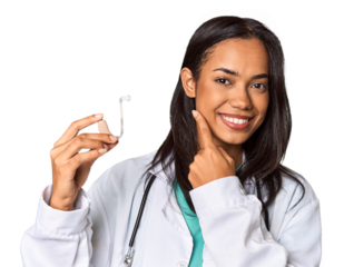 Young Filipina doctor holding hearing amplifier in studio