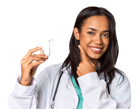 Young Filipina doctor holding hearing amplifier in studio