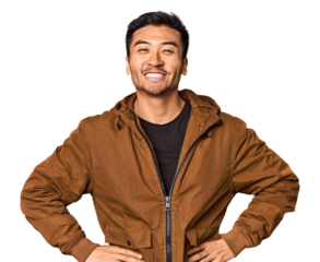 Young Chinese man in studio background confident keeping hands on hips.