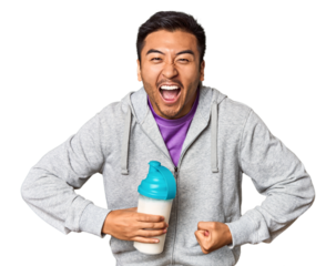Fit Chinese male with protein shake and bottle in studio setup