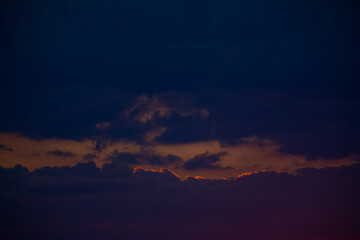 Orange sunrise on the horizon with emphasis on the sun's rays and birds in the distance. Idyllic Setting