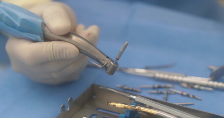 Doctor's hands with a working tool. Preparation and process of dental treatment. Dental instrument...
