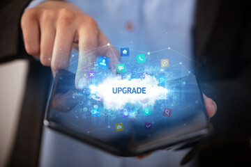 Businessman holding a foldable smartphone, technology concept