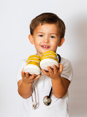 child shows shoes on a white background in a doctor's uniform