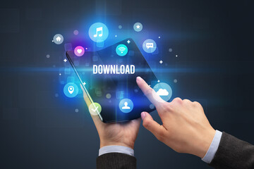 Fototapeta premium Businessman holding a foldable smartphone