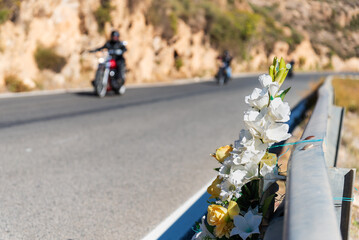 Bouquet of flowers tied to a highway guardrail in memory of a person who died in an accident with...