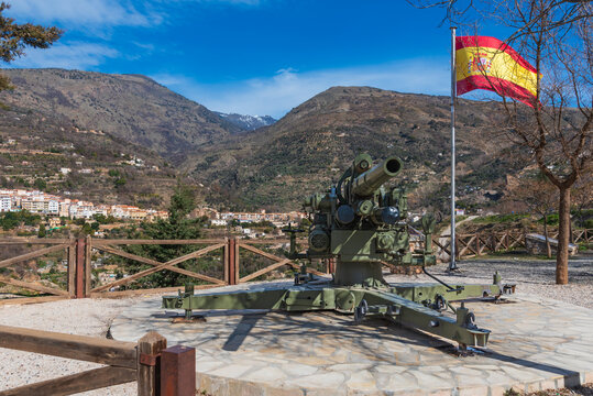 Cannon and flag of Spain at the Visillo viewpoint, Lanjaron, Granada, donated by the army to complete the cannon route in the town.