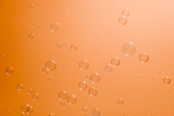 Soap bubbles in the orange sky. Beautifully iridescent balls of soap foam in the air