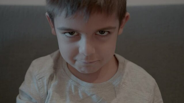 Adorable prescholl kid making funny face expressions. High quality 4k footage