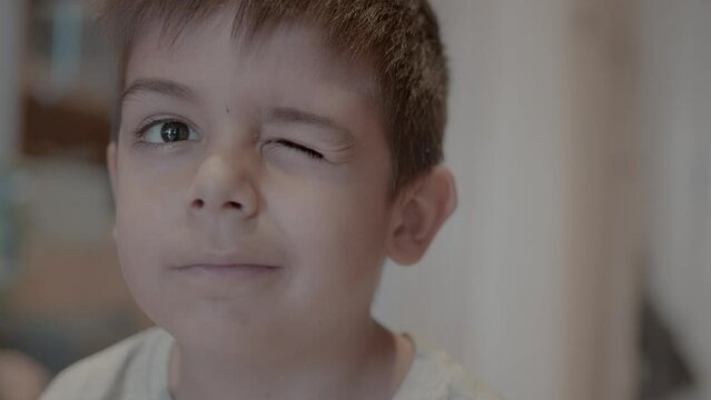 Portrait of adorable preschool child. Boy winking to camera. High quality 4k footage