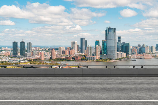 Empty urban asphalt road exterior with city buildings background. New modern highway concrete construction. Concept of way to success. Transportation logistic industry fast delivery. New York. USA.
