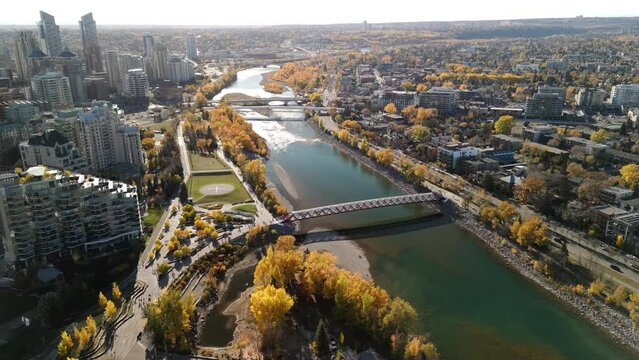 Prince's Island Park Peace Bridge autumn foliage scenery. Aerial view of Downtown City of Calgary. Alberta, Canada.