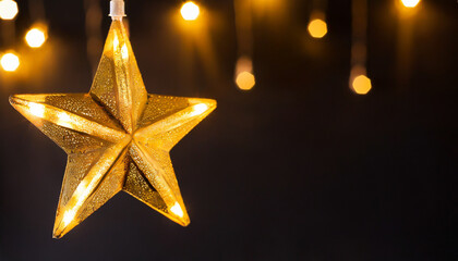 Gold star light hanging on dark background