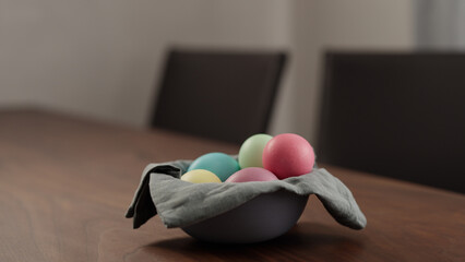 easter eggs in a bowl on walnut table