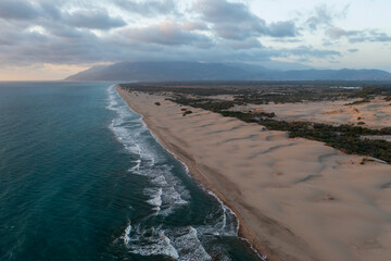 Beach and waves from top view. Turquoise water background from top view. Summer seascape with dunes from air. Top view from drone. Travel concept and idea