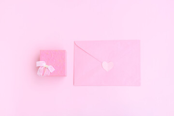 Pink envelope, Pink gift box and pink heart shape papercut on pink background, Love and Valentine concept