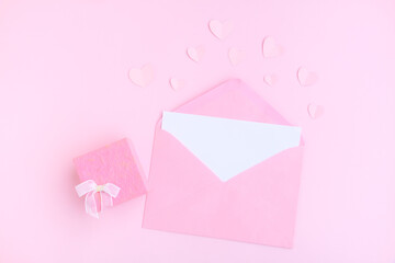 Pink envelope with white greeting card, Pink gift box and pink heart shape papercut on pink...