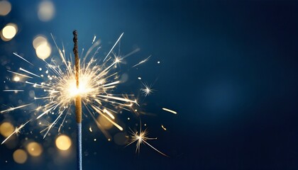 Sparkler burning bright with shiny sparks. Dark blue festive background. Happy New Year concept.