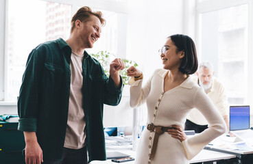 Successful male and female colleagues satisfied with brainstorming collaboration in office