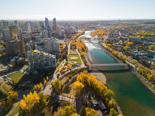 Prince's Island Park Peace Bridge autumn foliage scenery. Aerial view of Downtown City of Calgary....
