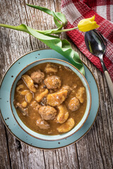 Meatballs in gravy with cast noodles.