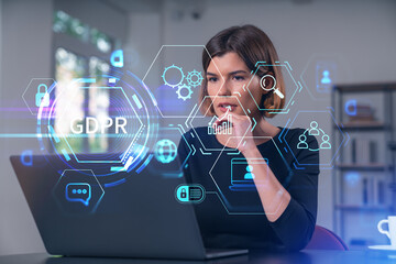 Pensive attractive beautiful businesswoman in formal wear working on laptop at office workplace in background. Concept of data protection information technology. lock icon hologram.