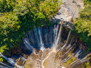 Aerial view from above, stunning view of Tumpak Sewu waterfall with many streams also known as Coban Sewu in East Java, Indonesia