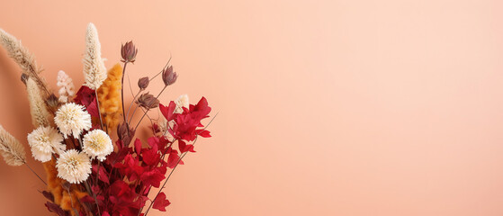 Minimalistic light background with a bouquet of dried colorful flowers on a light red wall. Beautiful background for presentation with with smooth floor.,