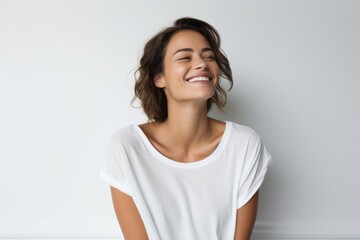 Fototapeta premium Portrait of a blissful woman in her 30s dressed in a casual t-shirt against a white background. AI Generation