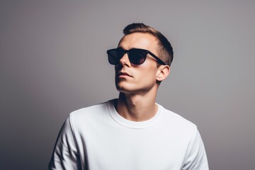Fototapeta premium Portrait of a glad man in his 30s wearing a trendy sunglasses against a white background. AI Generation