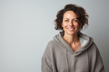 Obraz premium Portrait of a tender woman in her 40s dressed in a comfy fleece pullover against a white background. AI Generation