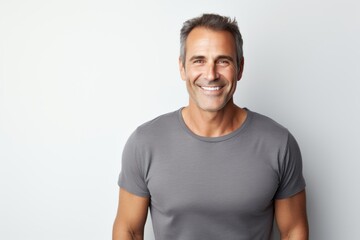 Obraz premium Portrait of a grinning man in his 40s donning a trendy cropped top against a white background. AI Generation