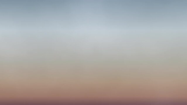 A hazy, vibrant sunset with cloud-streaked skies captured in a mesmerizing blurry image. The colors blend, inviting serene contemplation