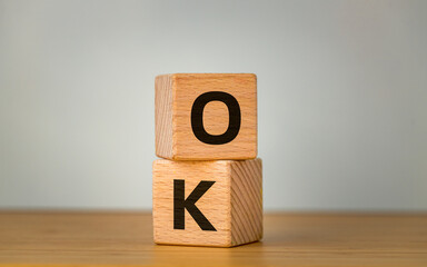 Ok, Positive symbol, Business concept, Word Ok on wooden cubes,  Beautiful bright background....