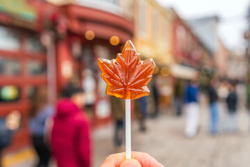 Naklejka premium Maple syrup candy on stick in Quebec City