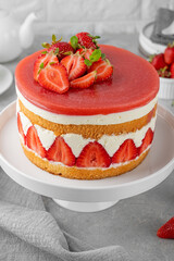 Fraisier mousse cake. Strawberry cake with sponge cake, mousse and jelly on a gray concrete background. Summer dessert. Selective focus. Copy space